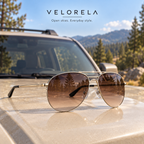 VELORELA Gold aviator sunglasses with brown lenses on parked SUV hood