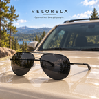VELORELA Gunmetal aviator sunglasses with black lenses on parked SUV hood