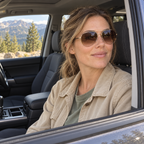 VELORELA Woman wearing gold and brown aviator sunglasses in a parked SUV passenger seat
