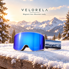 Velorela Blue / Snow Mountain magnetic snow goggles with the matching white frame and printed strap in an alpine snow scene