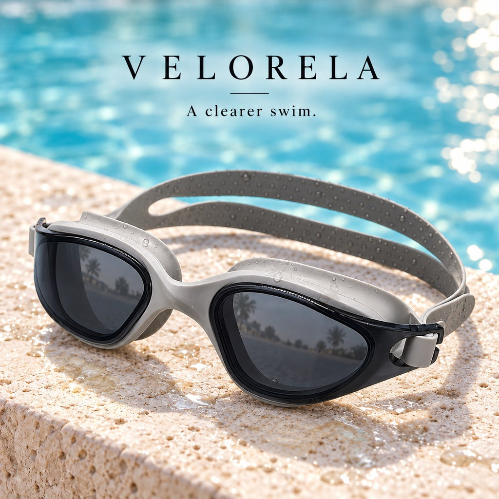 Velorela adult swimming goggles, Gray / Smoke, photographed at poolside.