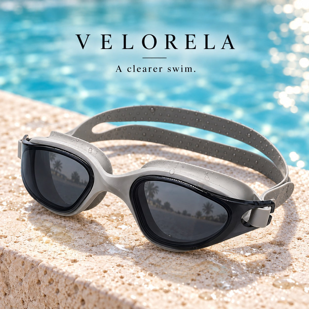 Velorela adult swimming goggles, Gray / Smoke, photographed at poolside.