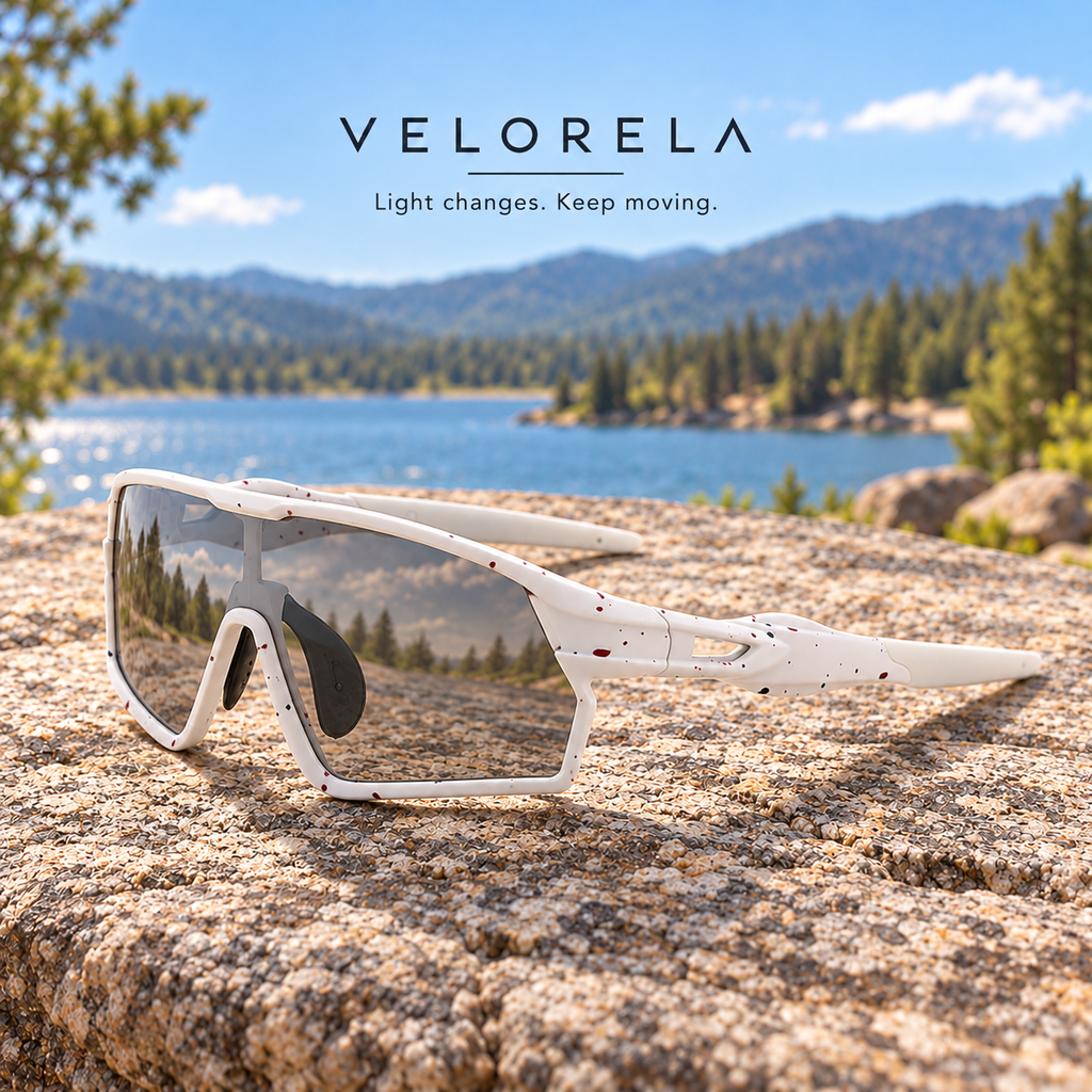 Velorela White photochromic sports sunglasses resting entirely on a lakeside granite rock