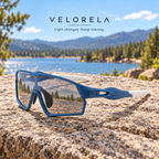 Velorela Blue photochromic sports sunglasses resting entirely on a lakeside granite rock
