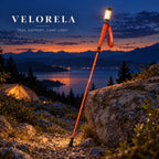 The full orange illuminated trekking pole resting against a rock at blue hour