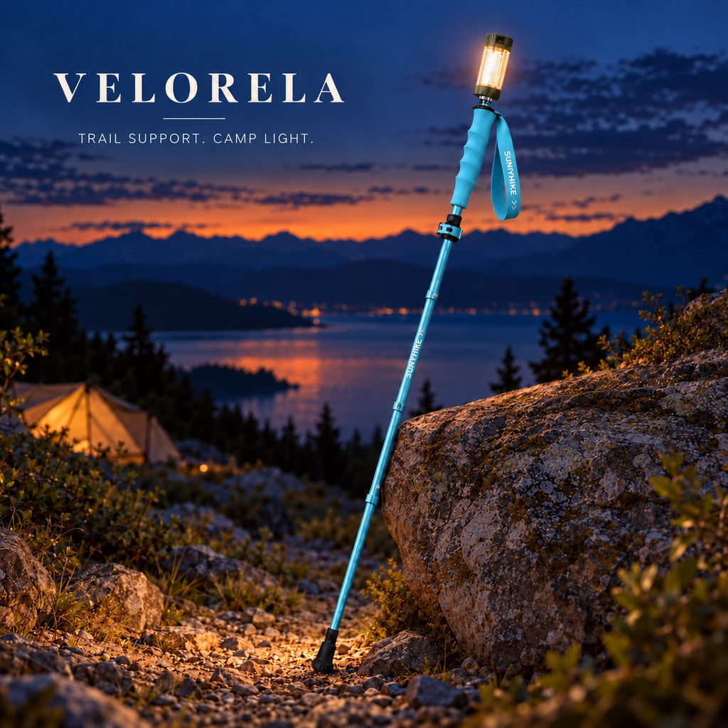 The full sky-blue illuminated trekking pole resting against a rock at blue hour